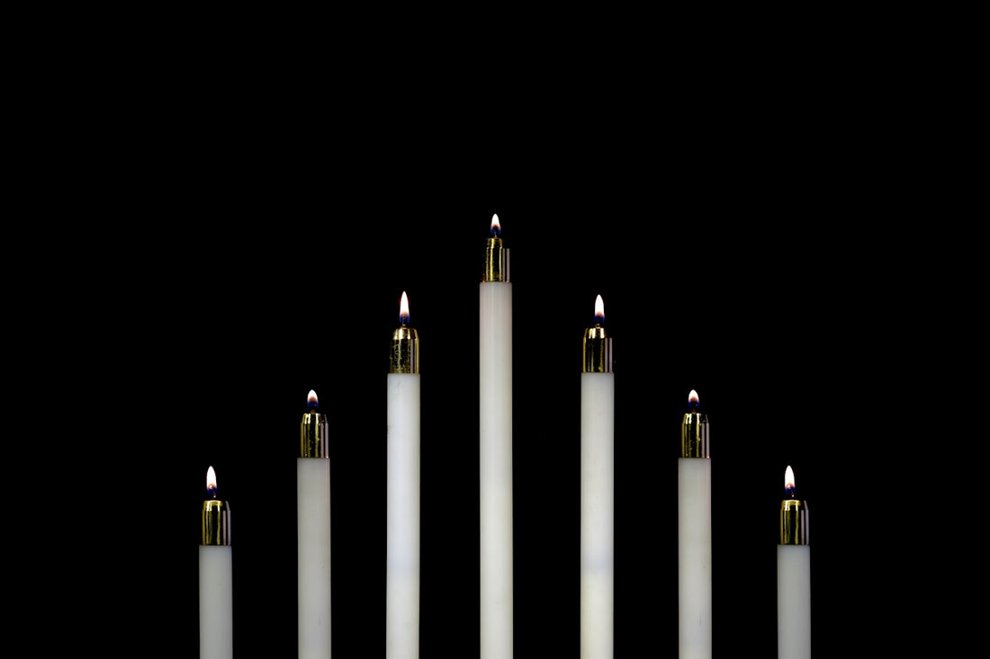 seven white candles closeup photography