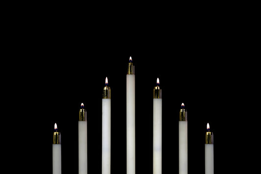 seven white candles closeup photography