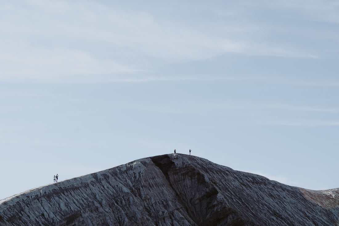 people walking on top of hill during day