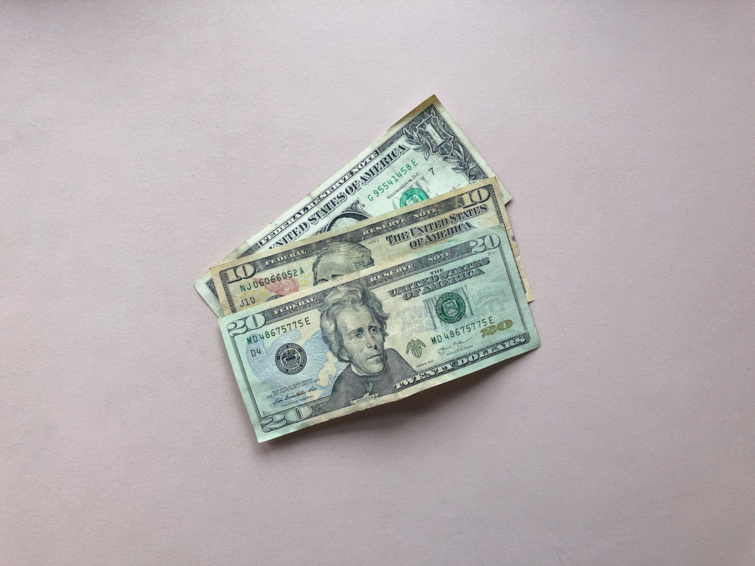 three assorted-denomination U.S. dollar banknotes