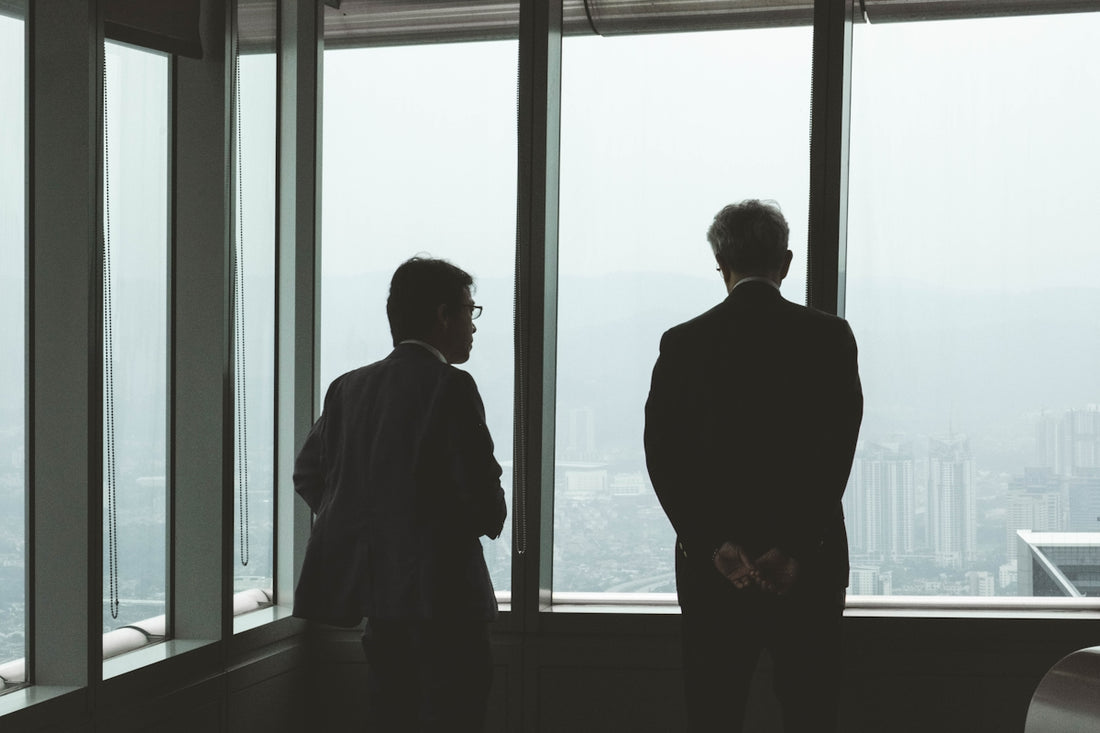 two men standing near window