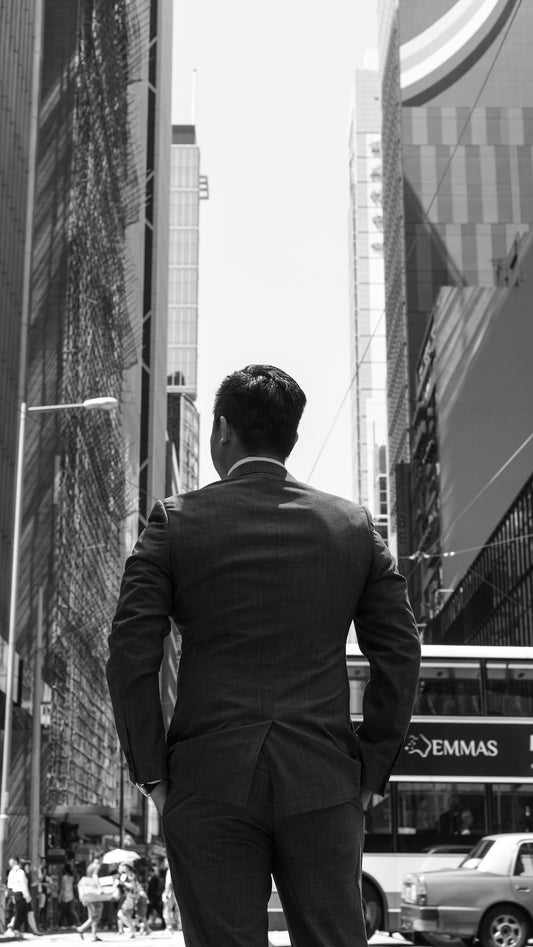 grayscale photography of man wearing blazer