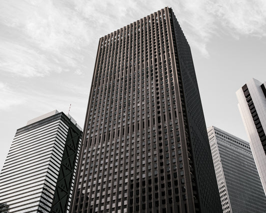 brown and black concrete building under white clouds during daytime