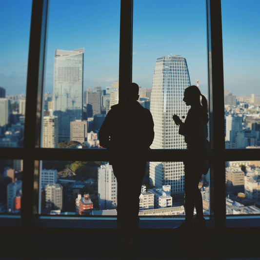 silhouette of man standing in front of glass window