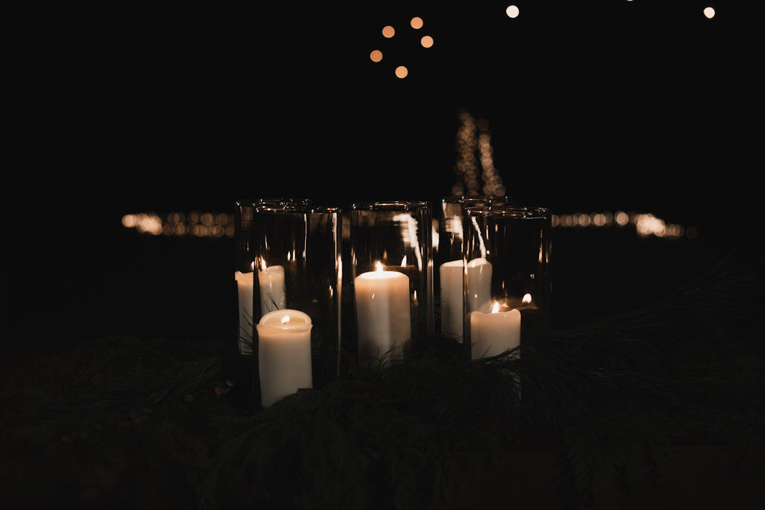 white pillar candles on black metal candle holder