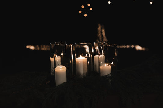 white pillar candles on black metal candle holder