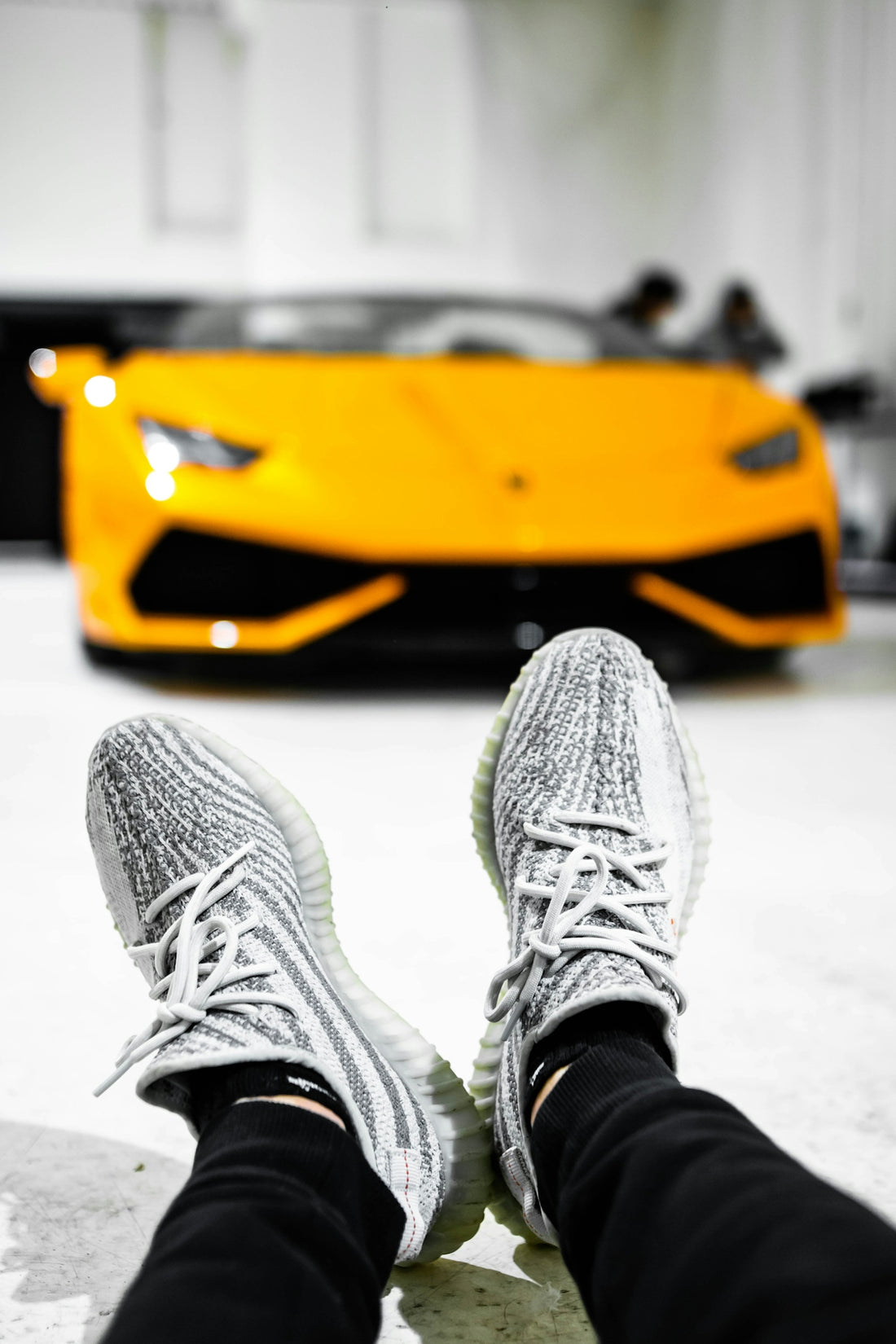 person in gray and white sneakers and black pants