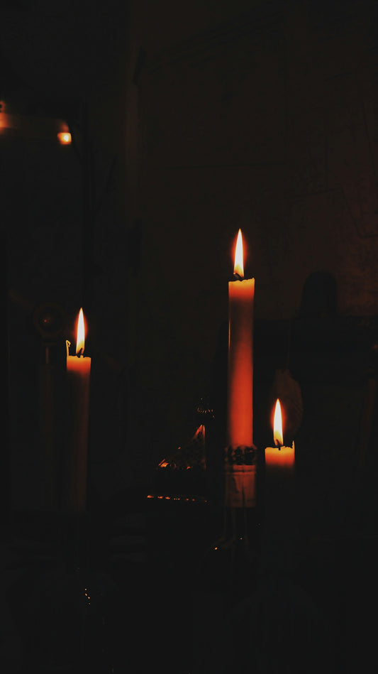 lighted candles on black surface