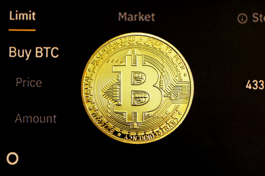 gold round coin on black surface