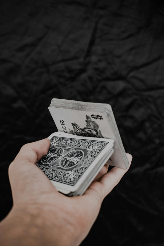 a person holding a playing card in their hand