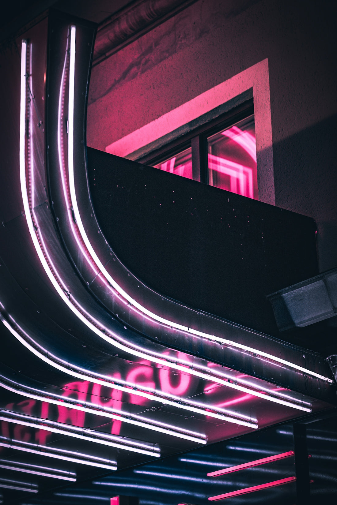 a neon sign that is on the side of a building