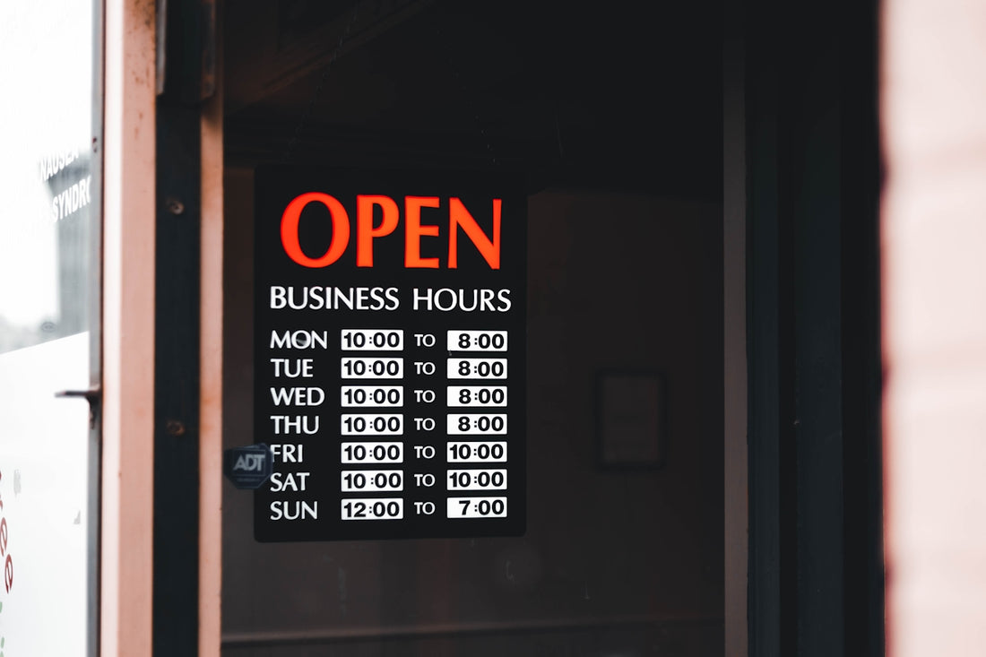 a sign on a door that says open business hours