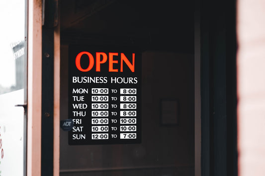 a sign on a door that says open business hours