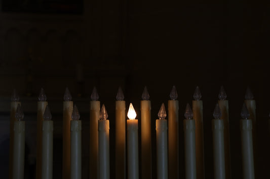 a group of lit candles sitting next to each other