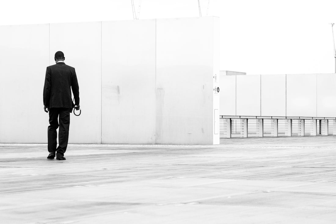 a man in a suit walking with a dog