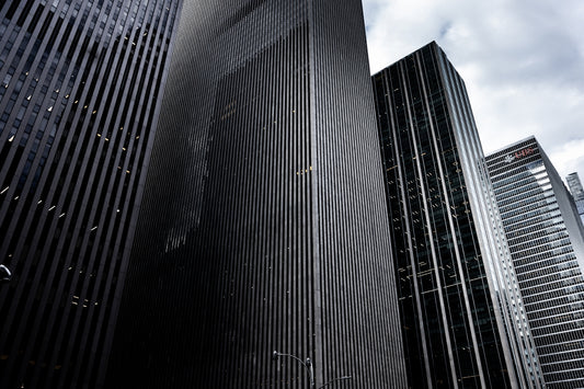 a couple of tall buildings sitting next to each other