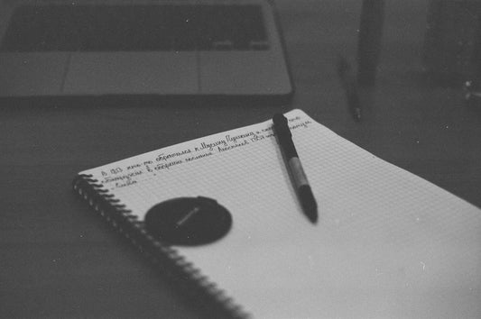 a notebook with a pen sitting on top of it