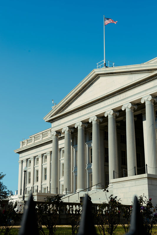 a large white building with a flag on top of it