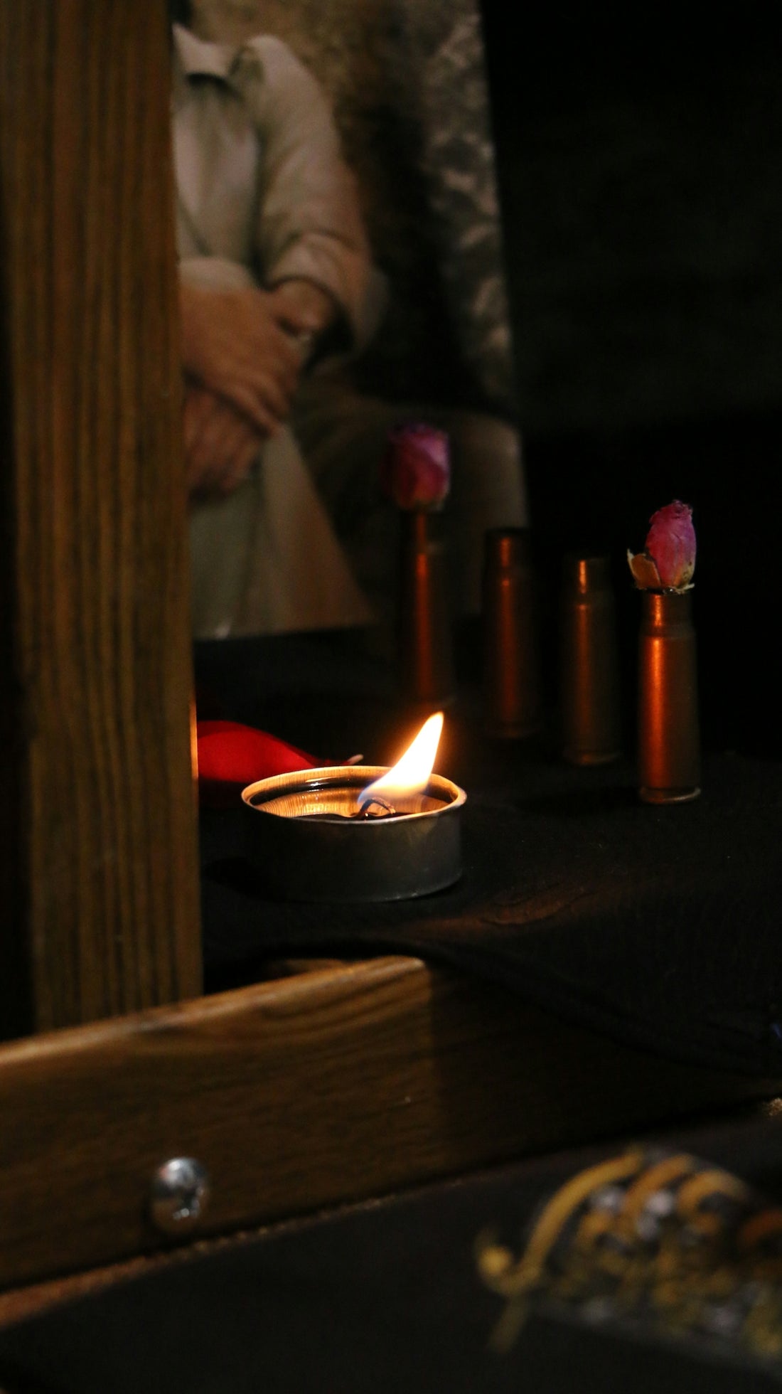 a lit candle sitting on top of a wooden table