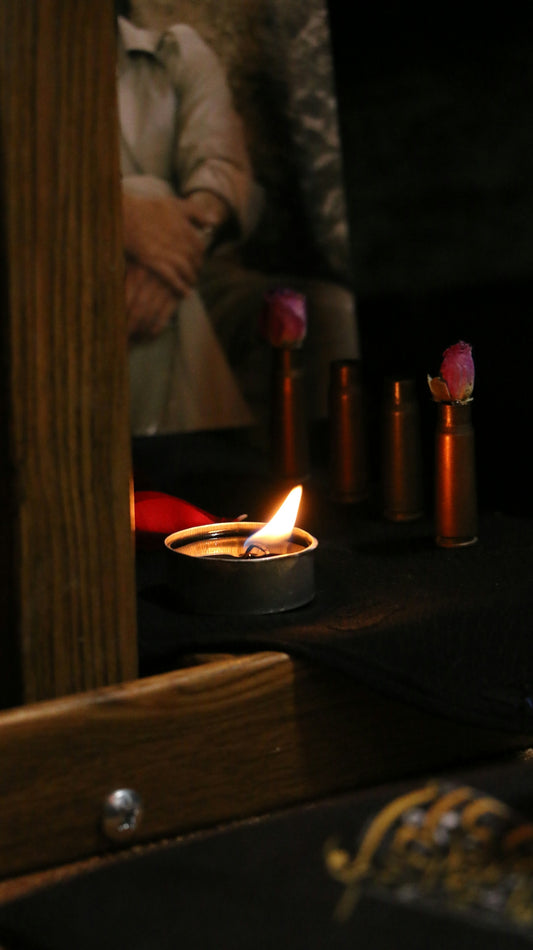 a lit candle sitting on top of a wooden table