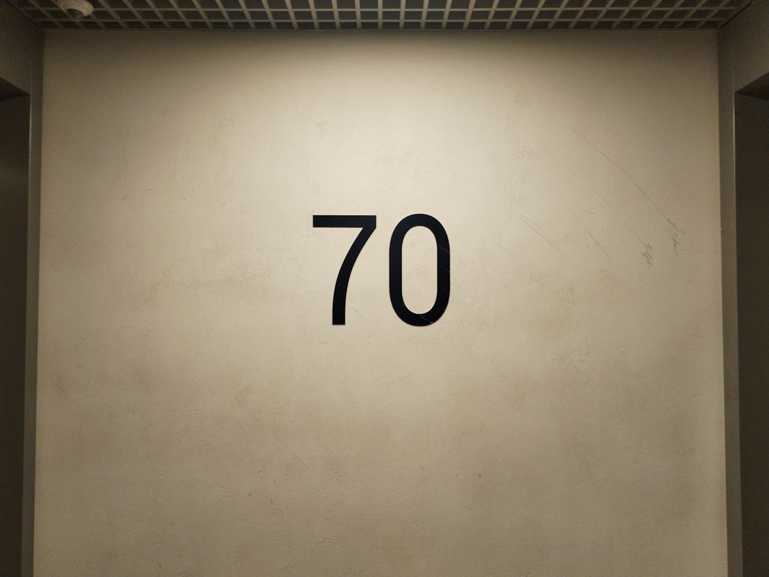 a white wall with a black number seventy on it