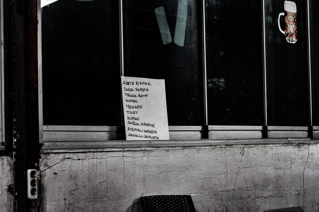 a black and white photo of a chair and a sign