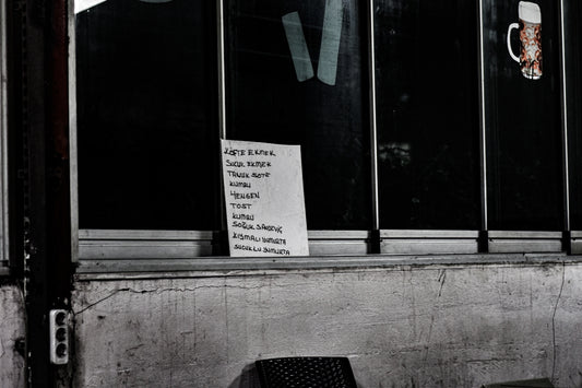 a black and white photo of a chair and a sign