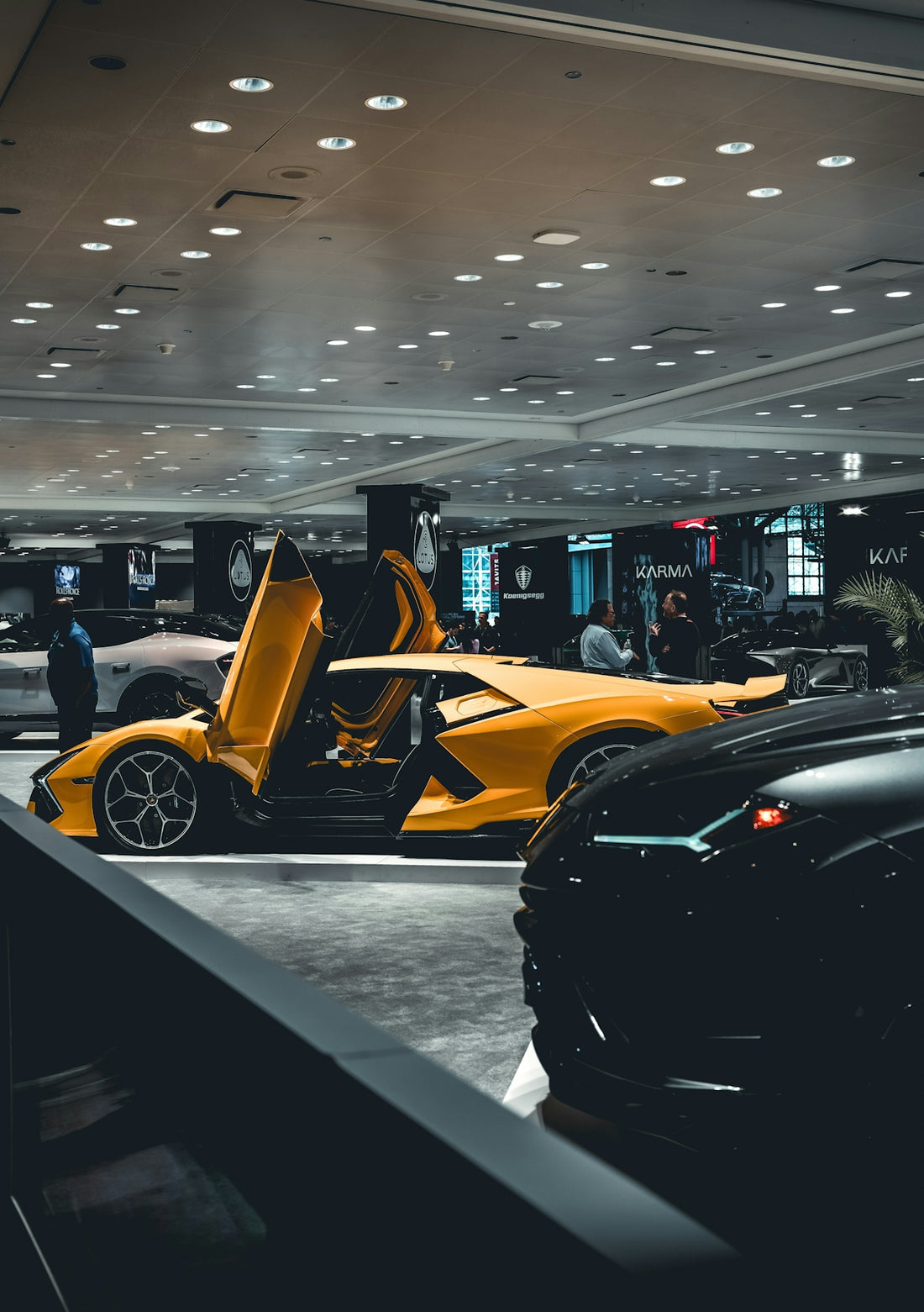 a yellow sports car parked in a showroom