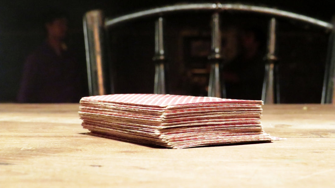 a stack of paper sitting on top of a wooden table