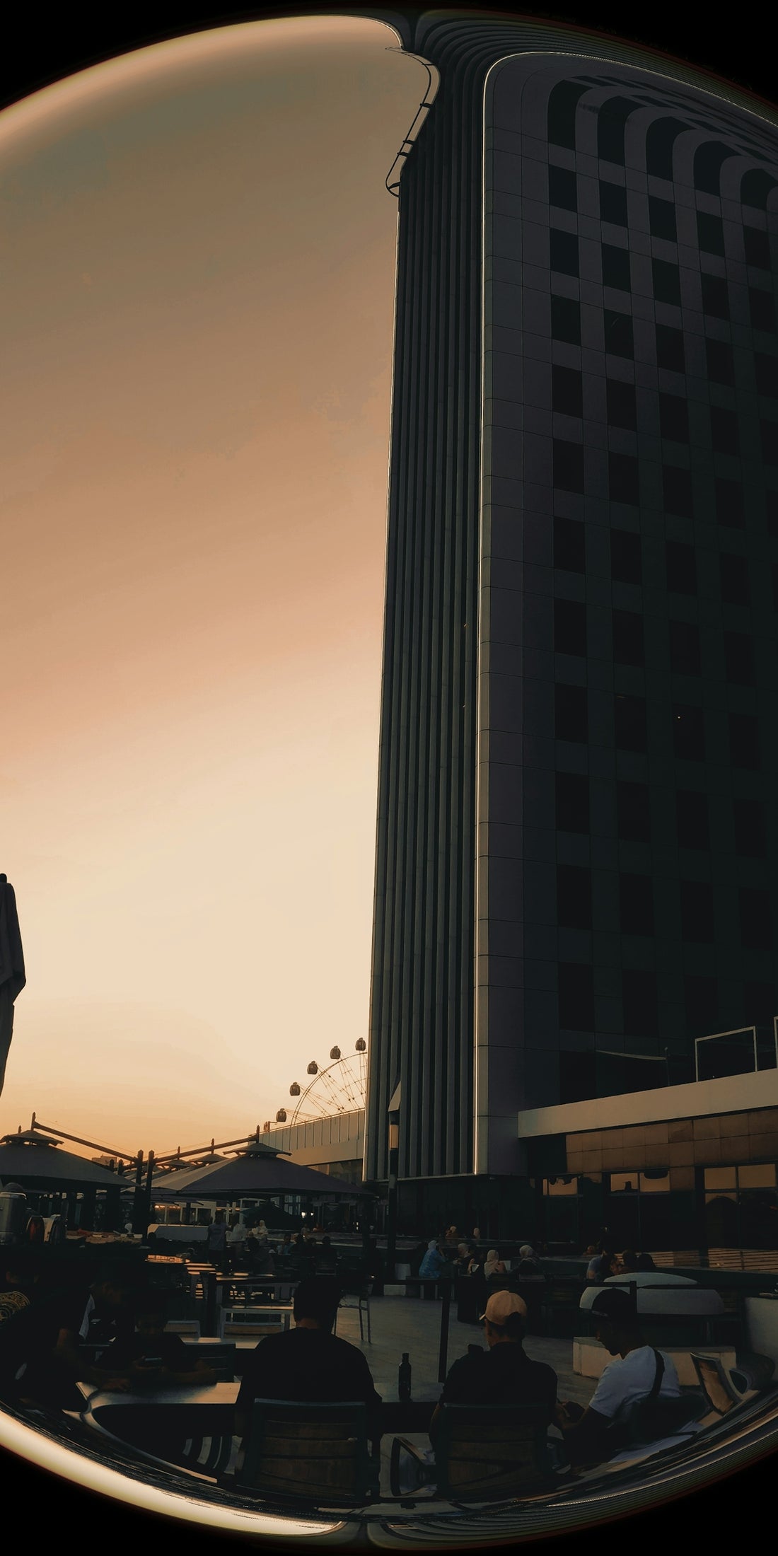 a man standing in front of a tall building
