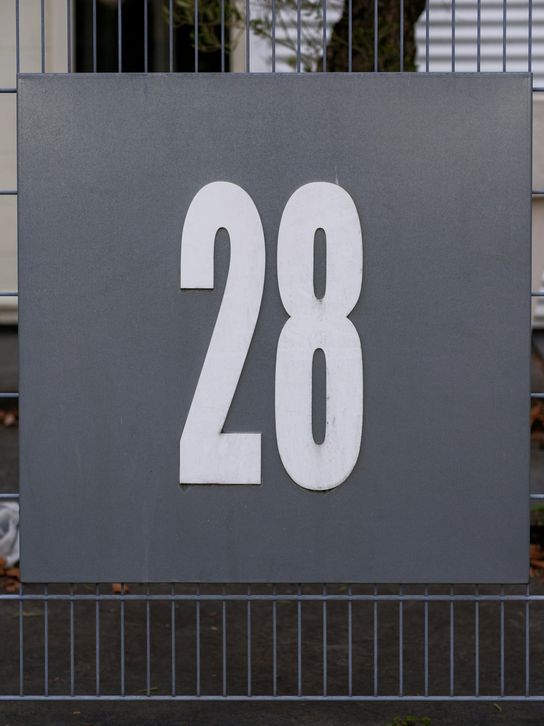 A large metal sign with the number 28 on it