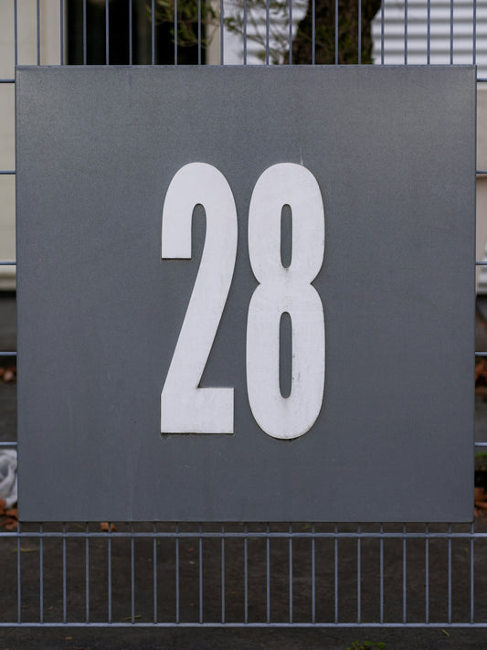 A large metal sign with the number 28 on it
