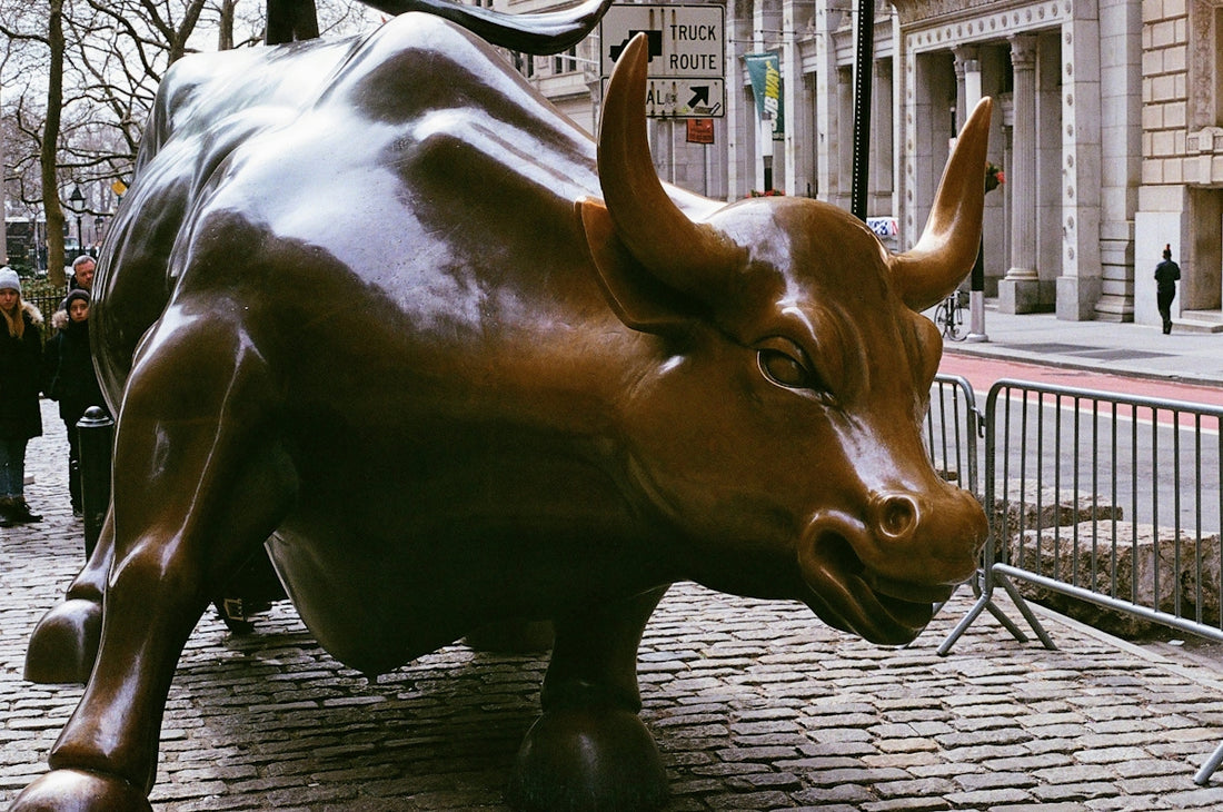 A statue of a bull on a city street