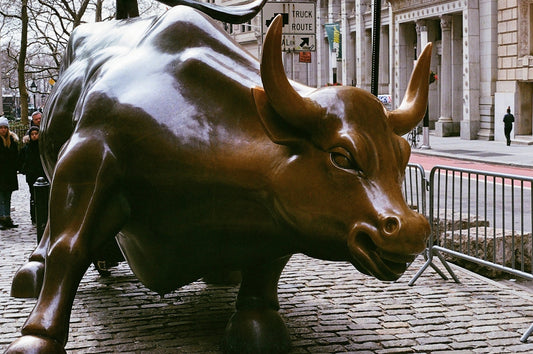 A statue of a bull on a city street