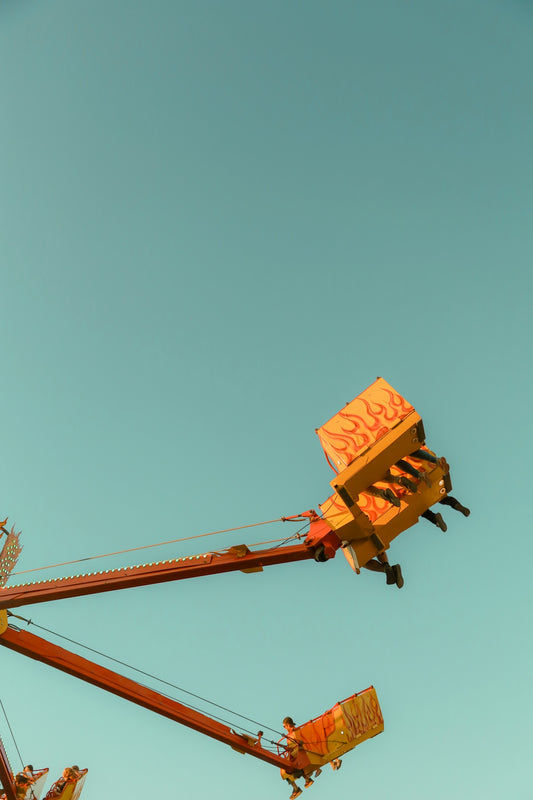 A carnival ride with a blue sky in the background