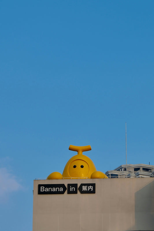 A tall clock tower with a smiley face on top