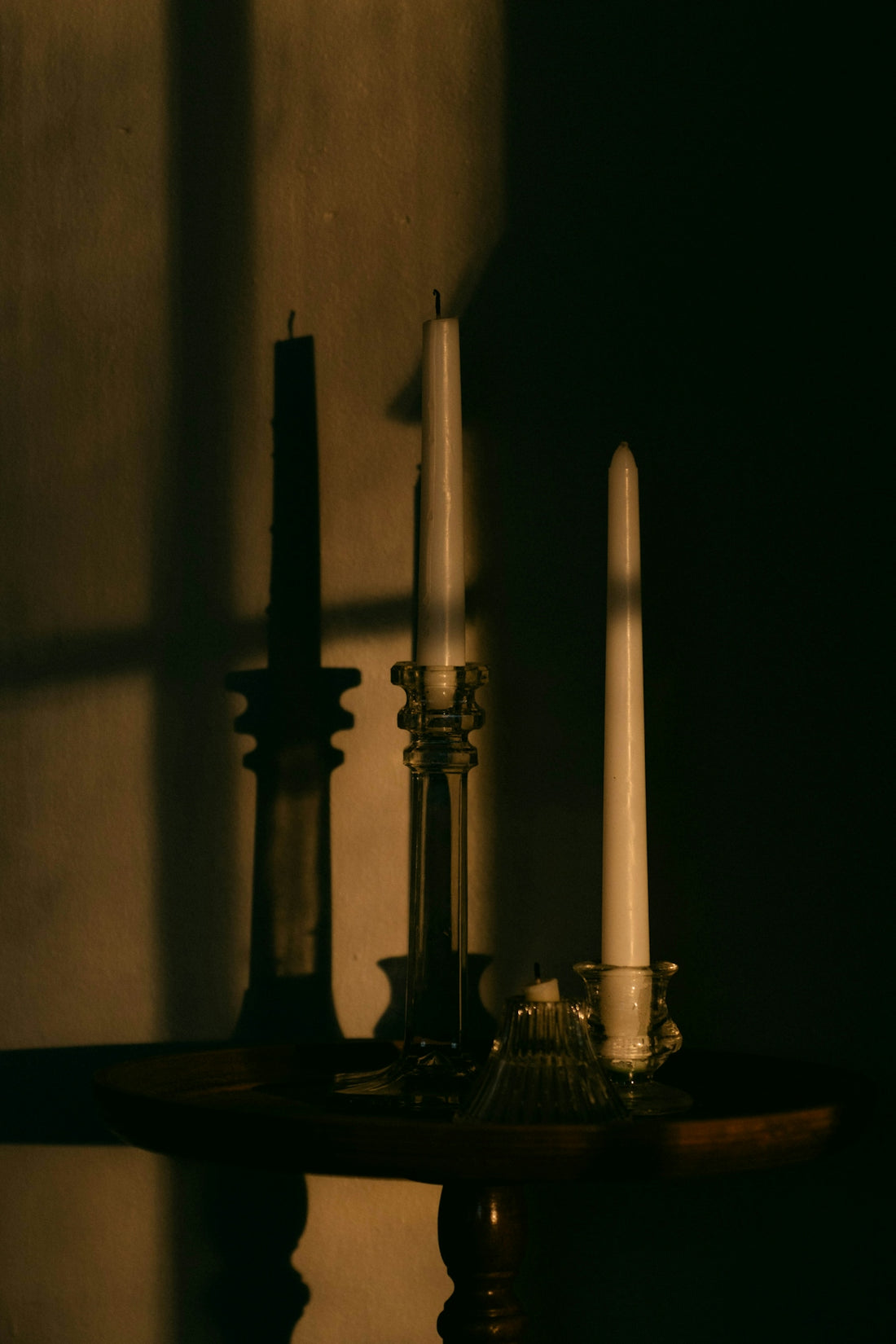 A table topped with two candles and a candle holder
