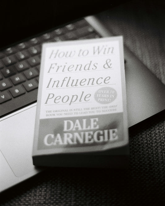 A book sitting on top of a laptop computer