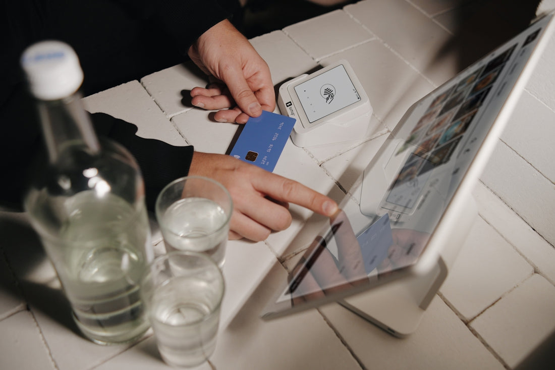 A person pays for their order on a tablet.