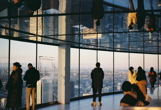 People admire a city's view from a building.