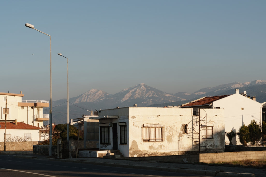 Houses and mountains are visible in the distance.
