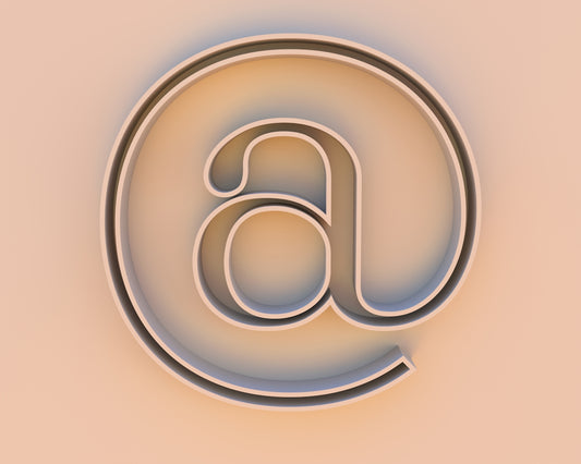 An at symbol on a beige background.
