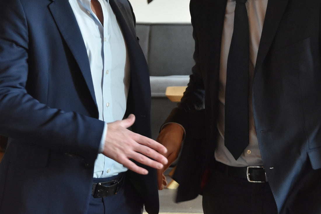 Businessmen are shaking hands in a professional gesture.