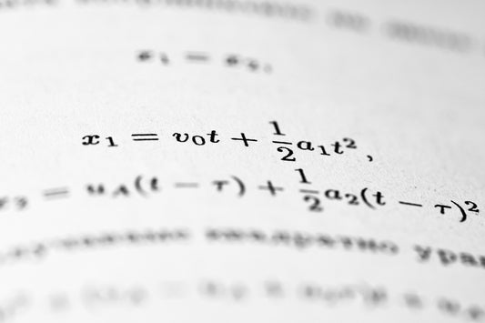 Mathematical formulas are written on the paper.