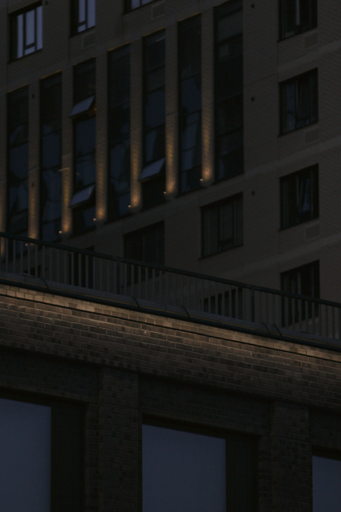 Modern buildings with illuminated windows at dusk.
