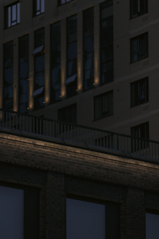 Modern buildings with illuminated windows at dusk.